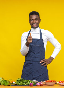 portrait of an african chef smiling and giving a thumbs up gesture